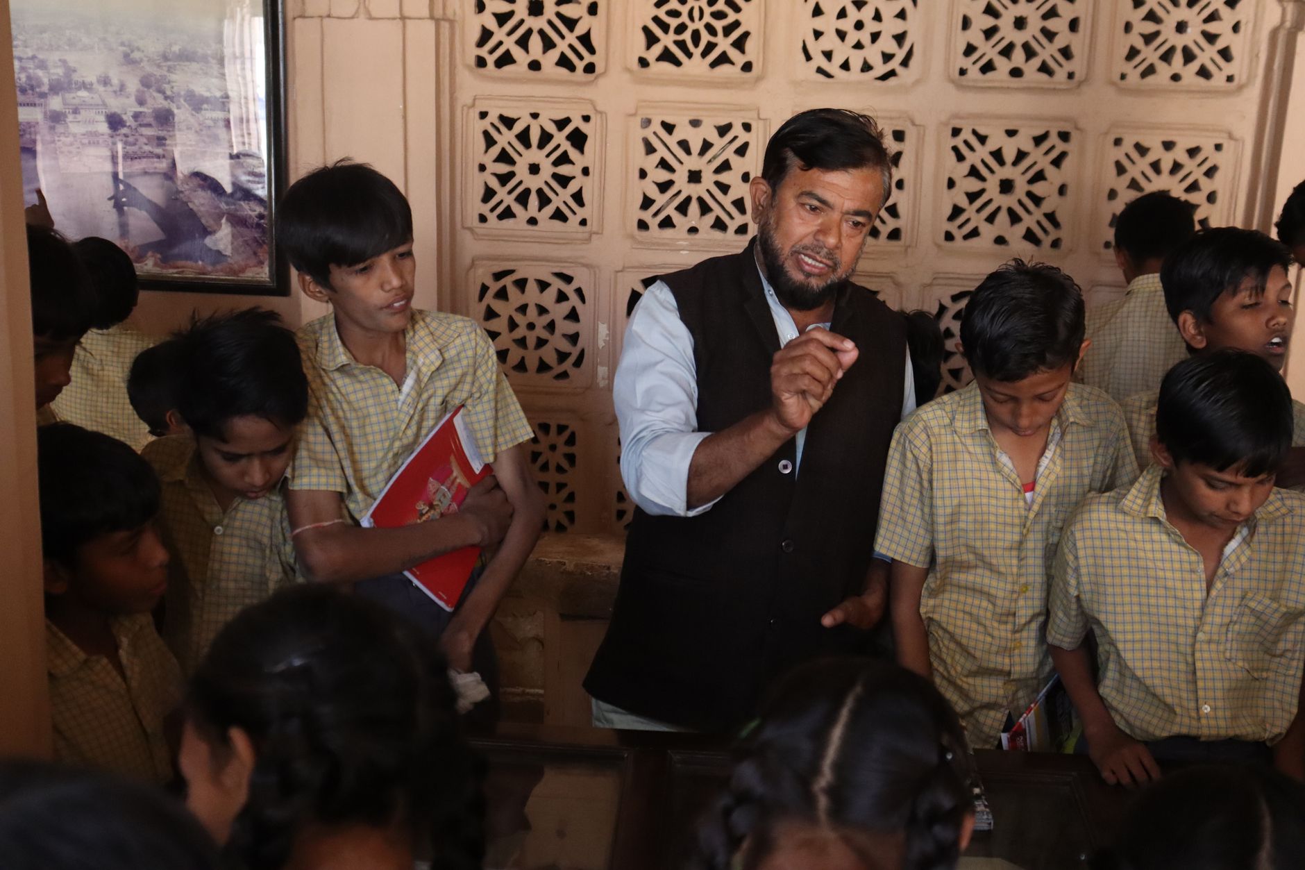 Teacher guiding attentive students during an interactive indoor lesson, fostering education. — Gap Year Abroad Program Focuse